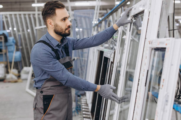 Factory worker handling window frames