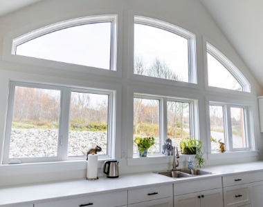 Arched kitchen windows above sink with natural light